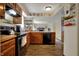 Inviting kitchen with wood cabinets, black appliances, and a view into the living area at 7344 Monon Cir, Indianapolis, IN 46256