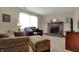 Cozy living room with a brick fireplace, plush seating, neutral carpet, and abundant natural light at 7344 Monon Cir, Indianapolis, IN 46256