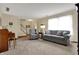 Inviting living room featuring soft furniture, plush carpet, and ample natural light at 7344 Monon Cir, Indianapolis, IN 46256