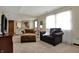 Comfortable living space with plush seating, and view into kitchen area creating an open and inviting atmosphere at 7344 Monon Cir, Indianapolis, IN 46256