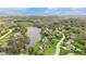 Beautiful aerial view of homes surrounding a scenic lake with docks and lush green landscaping at 7357 Windridge Way, Brownsburg, IN 46112