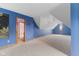 Attic featuring sloped ceilings, carpet, and a bright blue wall at 7357 Windridge Way, Brownsburg, IN 46112