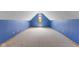 Spacious attic featuring sloped ceilings, carpet, and a bright blue wall at 7357 Windridge Way, Brownsburg, IN 46112