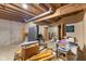 Unfinished basement space showing exposed rafters, pipes, and stored items, including exercise equipment at 7357 Windridge Way, Brownsburg, IN 46112