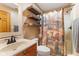 Bathroom with a sink, vanity, mirror, wooden shelves, and shower at 7357 Windridge Way, Brownsburg, IN 46112