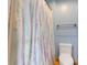 Bright bathroom with a white toilet, towel rack, and blue walls covered with a patterned shower curtain at 7357 Windridge Way, Brownsburg, IN 46112