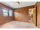 Bedroom with large window, wooden doors, and soft carpet at 7357 Windridge Way, Brownsburg, IN 46112