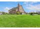 Expansive green lawn showcases this multi-story home with brick and siding exterior at 7357 Windridge Way, Brownsburg, IN 46112