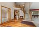 Spacious foyer with hardwood floors, staircase, and view into dining room and living spaces at 7357 Windridge Way, Brownsburg, IN 46112