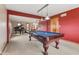 Game room features a pool table, grand piano, and a cozy seating area at 7357 Windridge Way, Brownsburg, IN 46112