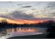 Serene lake at dawn with a blanket of fog over the water and a colorful sky at 7357 Windridge Way, Brownsburg, IN 46112