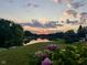 Gorgeous lake view at sunset, showcasing lush landscaping and peaceful surroundings at 7357 Windridge Way, Brownsburg, IN 46112