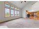 Spacious living room with vaulted ceilings and a wall of windows overlooking the lake at 7357 Windridge Way, Brownsburg, IN 46112