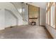 Bright living room features a stone fireplace, carpet, and staircase access at 7357 Windridge Way, Brownsburg, IN 46112