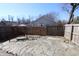Serene backyard featuring a stone patio, wooden swing, and secure fencing, creating a perfect outdoor retreat at 7438 Melanie Ln # 13, Indianapolis, IN 46217