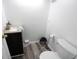 Cozy half-bathroom with modern fixtures, wood-style flooring and a corner toilet at 7438 Melanie Ln # 13, Indianapolis, IN 46217