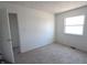 Clean bedroom featuring neutral carpets, natural light from the window, and an adjacent room at 7438 Melanie Ln # 13, Indianapolis, IN 46217