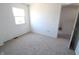 Bright bedroom features a window and neutral carpet at 7438 Melanie Ln # 13, Indianapolis, IN 46217