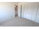 A clean, carpeted bedroom space featuring a large closet and doorway to another room at 7438 Melanie Ln # 13, Indianapolis, IN 46217