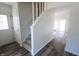 Inviting entryway with durable floors and a carpeted staircase leading to the upper level at 7438 Melanie Ln # 13, Indianapolis, IN 46217