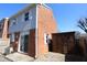 Exterior view featuring a brick facade, a storage shed, and a fenced yard at 7438 Melanie Ln # 13, Indianapolis, IN 46217