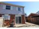 Rear exterior view of the house featuring a fenced yard, siding, and brick accents at 7438 Melanie Ln # 13, Indianapolis, IN 46217