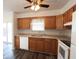 Inviting kitchen featuring wood cabinets, laminate countertops, white appliances, and ample natural light at 7438 Melanie Ln # 13, Indianapolis, IN 46217