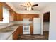 Well-lit kitchen featuring wooden cabinets, a white oven, and laminate countertops, with modern appliances at 7438 Melanie Ln # 13, Indianapolis, IN 46217