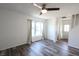 Bright, open-concept living room with modern wood flooring, large window, and views of the front entrance at 7438 Melanie Ln # 13, Indianapolis, IN 46217