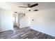 Spacious living room with modern flooring, fan, and staircase access at 7438 Melanie Ln # 13, Indianapolis, IN 46217