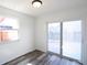 Bright room with wood floors, sliding glass door, and backyard access, filled with natural light at 7438 Melanie Ln # 13, Indianapolis, IN 46217