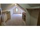 Finished carpeted attic featuring a window, shelving and closet space for storage or extra living area at 7474 Oakland Hills Dr, Indianapolis, IN 46236