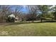 Spacious backyard with a well-maintained lawn and mature trees at 7474 Oakland Hills Dr, Indianapolis, IN 46236