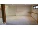 The carpeted basement offers ample space and a built-in ledge; perfect for storage or workspace at 7474 Oakland Hills Dr, Indianapolis, IN 46236