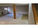 This finished basement features a wooden support beam, carpeted floor, and a window for natural light at 7474 Oakland Hills Dr, Indianapolis, IN 46236