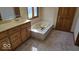 Bathroom featuring white vanity and a soaking tub, perfect for relaxing after a long day at 7474 Oakland Hills Dr, Indianapolis, IN 46236