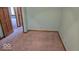 This spacious bedroom features neutral carpet and pale blue walls creating a calming atmosphere at 7474 Oakland Hills Dr, Indianapolis, IN 46236