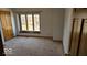 Carpeted bedroom with large window providing natural light and ample space at 7474 Oakland Hills Dr, Indianapolis, IN 46236