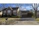 Charming two-story brick home with a well-maintained lawn and mature landscaping at 7474 Oakland Hills Dr, Indianapolis, IN 46236