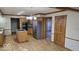 Spacious kitchen features stainless steel refrigerator and granite countertops with an island and wood cabinets at 7474 Oakland Hills Dr, Indianapolis, IN 46236