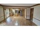 Open floor plan with hardwood floors connecting the kitchen with stainless steel appliances at 7474 Oakland Hills Dr, Indianapolis, IN 46236