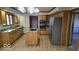 Bright kitchen features stainless steel refrigerator, granite countertops, wood cabinets and an island with cooktop at 7474 Oakland Hills Dr, Indianapolis, IN 46236