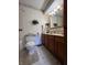 Bathroom vanity featuring a wooden cabinet, ample lighting, and tile flooring at 7632 S Sherman Dr, Indianapolis, IN 46237