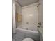 Bathroom showcasing a soaking tub with tile surround and neutral color palette at 7632 S Sherman Dr, Indianapolis, IN 46237