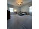 Spacious bedroom with plush carpeting, natural light, and a ceiling fan at 7632 S Sherman Dr, Indianapolis, IN 46237