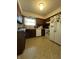 Galley kitchen with brown cabinets and white appliances at 7632 S Sherman Dr, Indianapolis, IN 46237