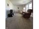 Cozy living room featuring carpet, seating, and a large window, offering a comfortable space at 7632 S Sherman Dr, Indianapolis, IN 46237