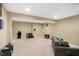 Spacious finished basement with neutral walls and plush carpet, offering versatility for various activities at 7710 Eagle Crescent Dr, Zionsville, IN 46077