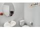 Clean powder room with a round mirror, white sink, toilet, and simple decor adding a modern touch at 7710 Eagle Crescent Dr, Zionsville, IN 46077