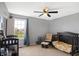 Comfortable Bedroom with a dark wood crib and seating, perfect for a growing Gathering at 7710 Eagle Crescent Dr, Zionsville, IN 46077